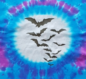 Tie dye Halloween shirt with colours of pink and purple and closeup of the silver moon with black Bats flying across the Moon