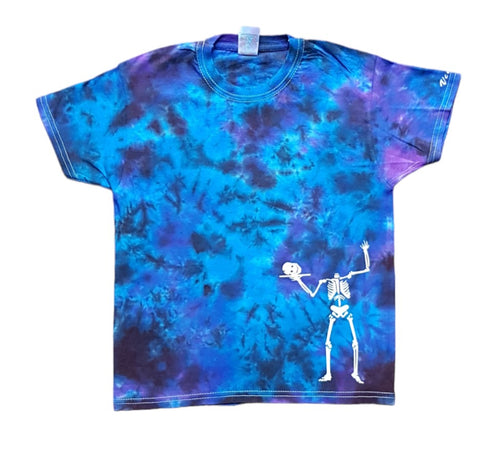 Halloween headless skeleton design tie dye shirt. The overall colour of the shirt is a mix of blue and purple hues in a scrunch pattern. The headless skeleton is in white at the bottom corner of the shirt