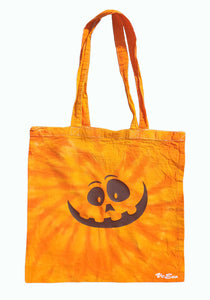 Halloween Smiling Pumpkin design tie dye tote bag. Overall colour of the bag is various shades of orange in swirl pattern with black Smiling Pumpkin