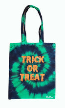 Load image into Gallery viewer, Halloween Trick or Treat design tie dye tote bag. Overall colour of the bag is green and black in swirl pattern with orange trick or treat text