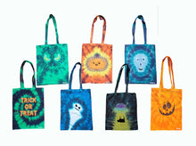 Load image into Gallery viewer, Various Halloween designs tie dye tote bag. Top row includes the designs Evil Eyes, Cute Pumpkin and Skull Face. The bottom row includes Trick or Treat text, Ghost, Cow being abducted by a UFO and a Smiling Pumpkin