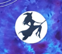 Closeup of the black flying witch on a broom  across a glow in the dark moon