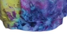 Load image into Gallery viewer, Ice tie dyed Northern Lights inspired hoodie. Overall blue and purple colour scheme with a lime green band diagonal from bottom left to right shoulder. Close up of the double stitched hem