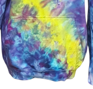 Ice tie dyed Northern Lights inspired hoodie. Overall blue and purple colour scheme with a lime green band diagonal from bottom left to right shoulder. Close up of the kangaroo pouch